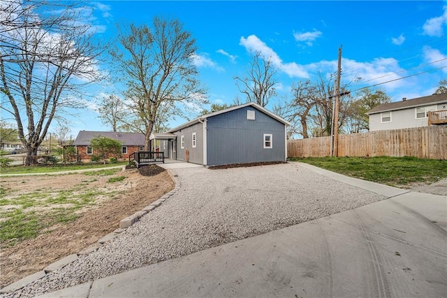 exterior space with driveway and fence