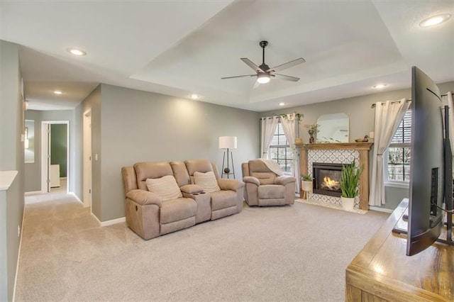 living area featuring a healthy amount of sunlight, baseboards, and carpet