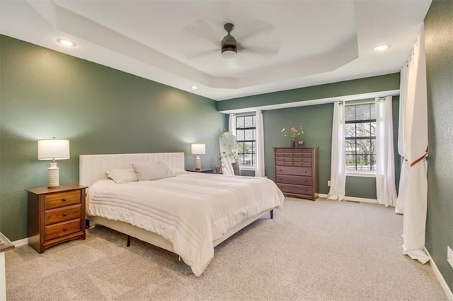 bedroom featuring light carpet and baseboards