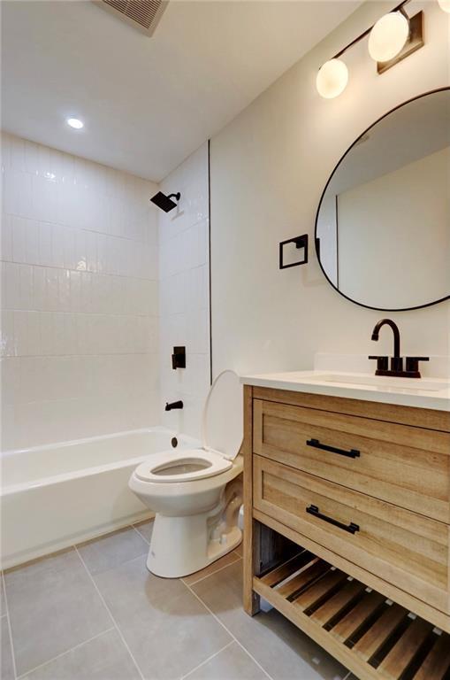 full bath with vanity, visible vents, toilet, washtub / shower combination, and tile patterned floors