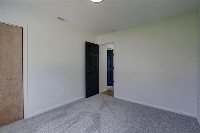 unfurnished bedroom with visible vents, baseboards, and carpet floors