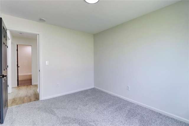empty room with baseboards and carpet floors