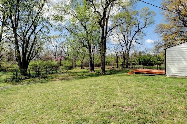 view of yard with a deck and fence