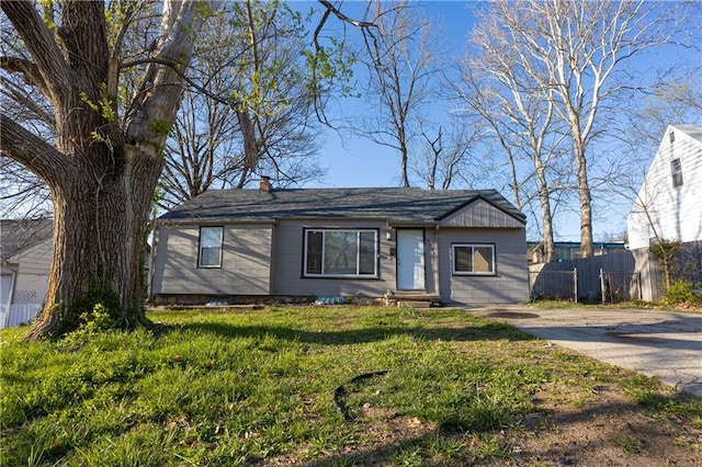 9904 E 60th Ter, Raytown, MO 64133 - single story home featuring a chimney, fence, and a front lawn