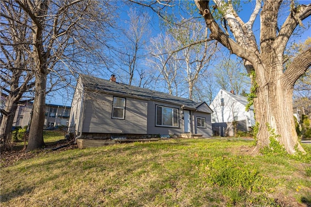 9904 E 60th Ter, Raytown, MO 64133 - view of front of house featuring a front yard, fence, and a chimney