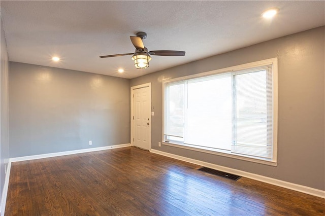 9904 E 60th Ter, Raytown, MO 64133 - empty room featuring visible vents, baseboards, a ceiling fan, and wood finished floors