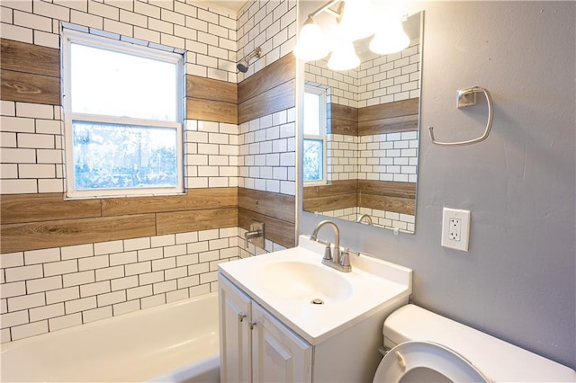 9904 E 60th Ter, Raytown, MO 64133 - bathroom with a wealth of natural light,  shower combination, vanity, and toilet