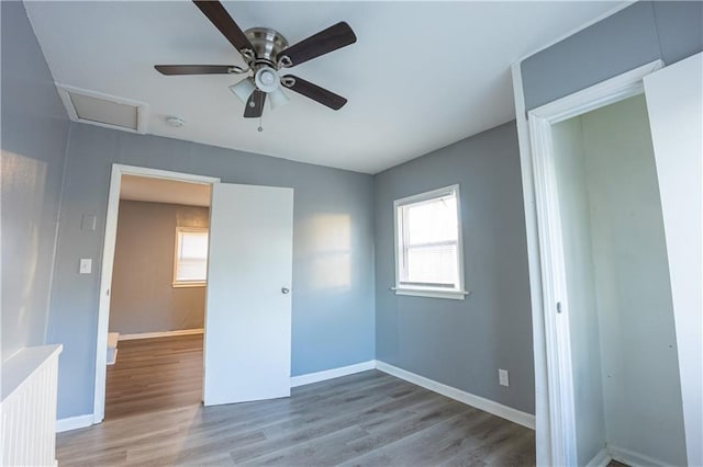 9904 E 60th Ter, Raytown, MO 64133 - unfurnished bedroom with baseboards, attic access, a ceiling fan, and wood finished floors