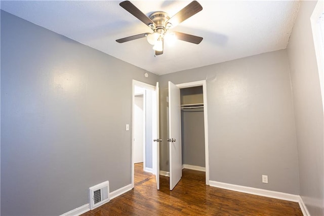 9904 E 60th Ter, Raytown, MO 64133 - unfurnished bedroom with ceiling fan, a closet, visible vents, wood finished floors, and baseboards