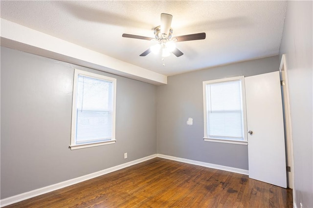 9904 E 60th Ter, Raytown, MO 64133 - spare room with baseboards, ceiling fan, wood finished floors, and a healthy amount of sunlight