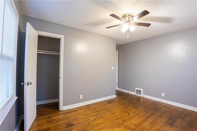 9904 E 60th Ter, Raytown, MO 64133 - unfurnished bedroom featuring visible vents, a closet, baseboards, and wood finished floors