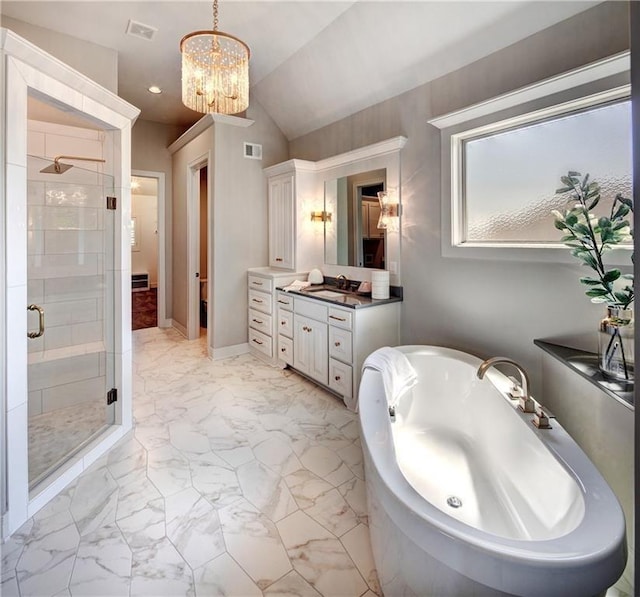 16046 S Twilight Ln, Olathe, KS 66062 - full bathroom with a stall shower, marble finish flooring, a freestanding bath, a chandelier, and vanity
