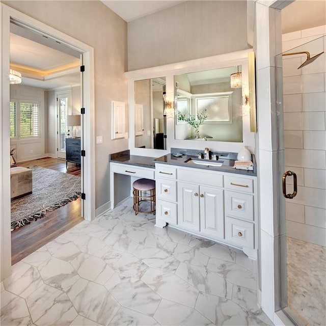 16046 S Twilight Ln, Olathe, KS 66062 - ensuite bathroom featuring a shower stall, baseboards, vanity, and marble look tiles