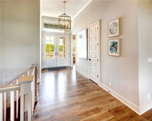 16046 S Twilight Ln, Olathe, KS 66062 - foyer entrance featuring a chandelier, french doors, baseboards, wood finished floors, and ornamental molding