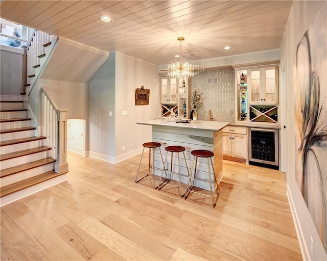 16046 S Twilight Ln, Olathe, KS 66062 - indoor dry bar with beverage cooler, baseboards, stairs, recessed lighting, and hanging light fixtures