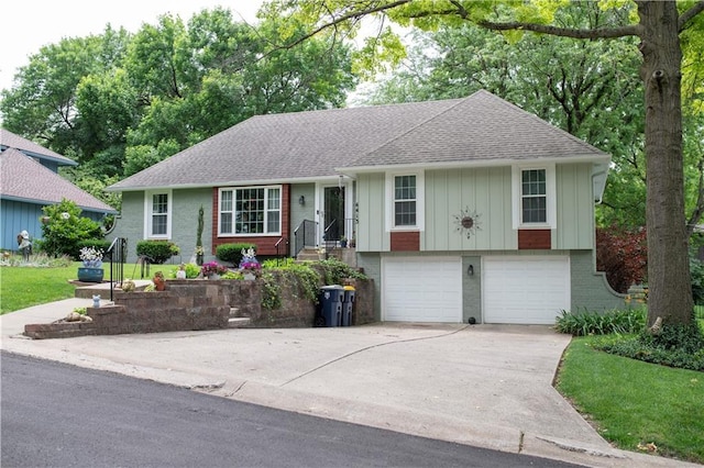4413 E 107th St, Kansas City, MO 64137 - view of front of home with roof with shingles, board and batten siding, brick siding, driveway, and a garage