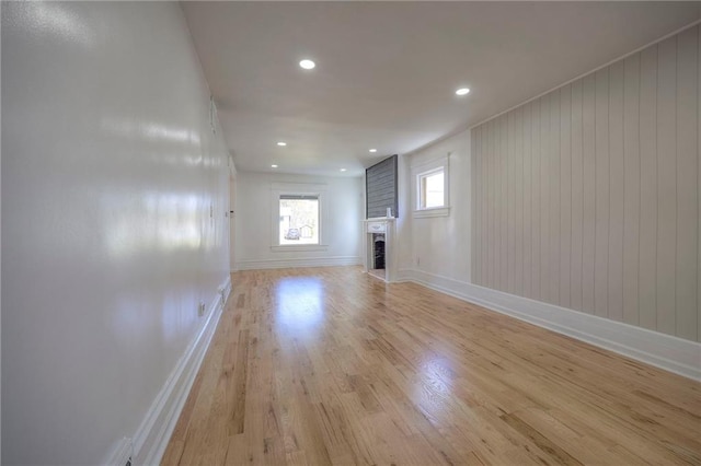 1607 E 37th St, Kansas City, MO 64109 - unfurnished living room featuring light wood-style flooring, baseboards, a fireplace, and recessed lighting