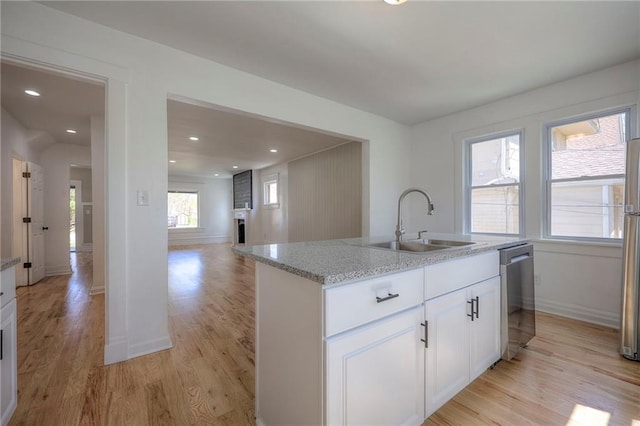 1607 E 37th St, Kansas City, MO 64109 - kitchen featuring a sink, stainless steel appliances, light wood finished floors, light stone countertops, and recessed lighting