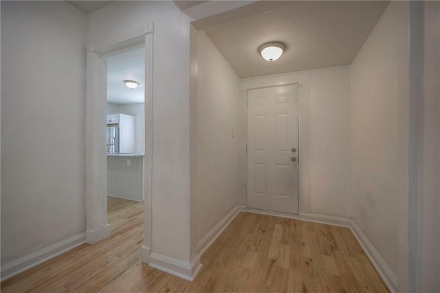 1607 E 37th St, Kansas City, MO 64109 - hallway with light wood-style flooring and baseboards