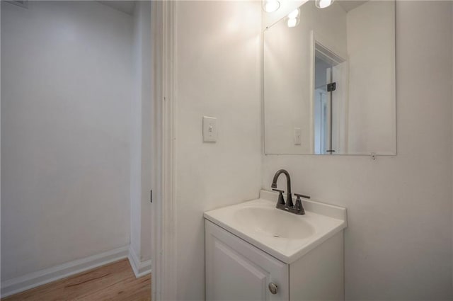 1607 E 37th St, Kansas City, MO 64109 - bathroom with vanity and wood finished floors