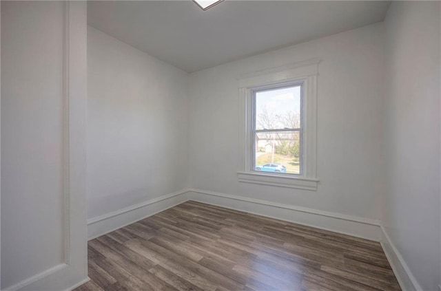 1607 E 37th St, Kansas City, MO 64109 - empty room with dark wood finished floors and baseboards