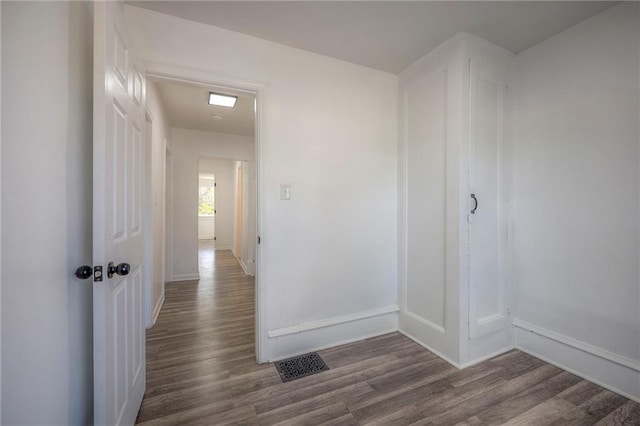 1607 E 37th St, Kansas City, MO 64109 - hall featuring dark wood-style flooring and baseboards