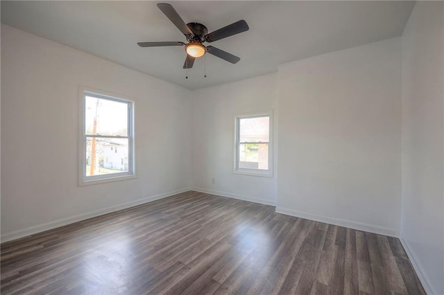 1607 E 37th St, Kansas City, MO 64109 - empty room featuring dark wood finished floors, baseboards, and a ceiling fan