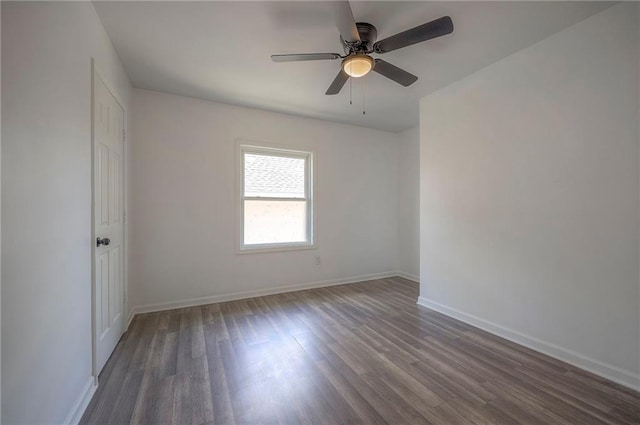 1607 E 37th St, Kansas City, MO 64109 - unfurnished room with wood finished floors, ceiling fan, and baseboards