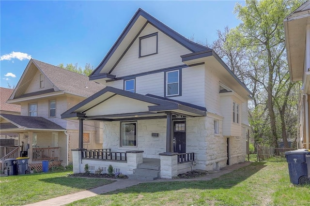1607 E 37th St, Kansas City, MO 64109 - view of front of home featuring stone siding and covered porch