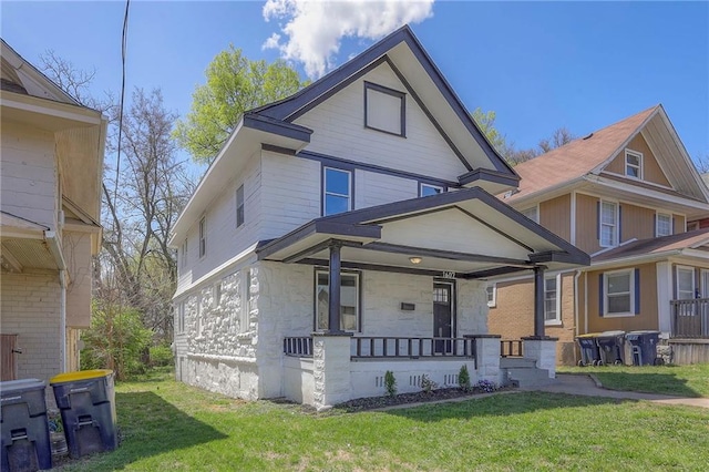 1607 E 37th St, Kansas City, MO 64109 - view of front of home featuring covered porch, a front lawn, and stone siding