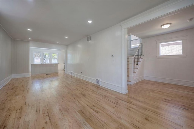 1607 E 37th St, Kansas City, MO 64109 - unfurnished room with light wood-style floors, stairway, baseboards, and recessed lighting