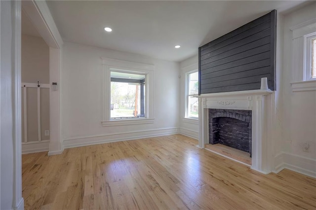 1607 E 37th St, Kansas City, MO 64109 - unfurnished living room featuring a fireplace, light wood-style floors, baseboards, and recessed lighting