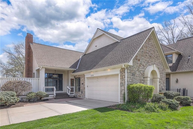view of front of property with a garage, driveway, stone siding, and stucco siding