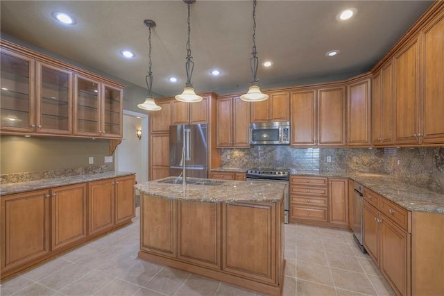 kitchen featuring brown cabinets, light tile patterned flooring, and appliances with stainless steel finishes