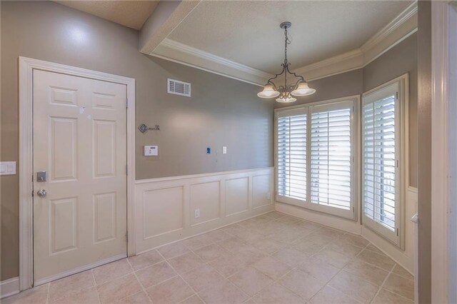 unfurnished dining area featuring a notable chandelier, visible vents, crown molding, and light tile patterned flooring