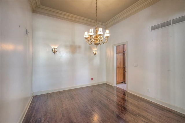 empty room featuring wood finished floors, visible vents, crown molding, and an inviting chandelier