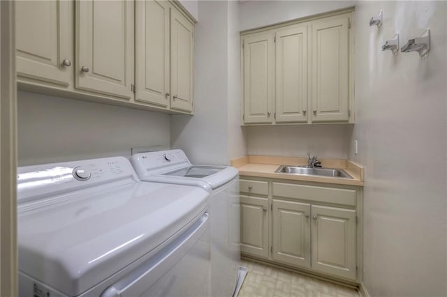 laundry room featuring a sink, cabinet space, and washer and dryer