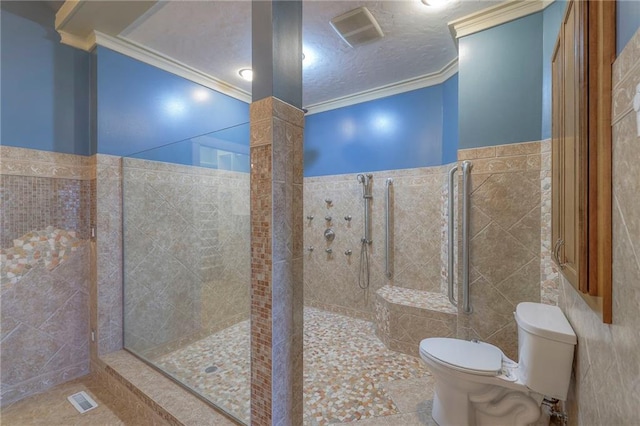 bathroom with crown molding, tile walls, toilet, and a walk in shower