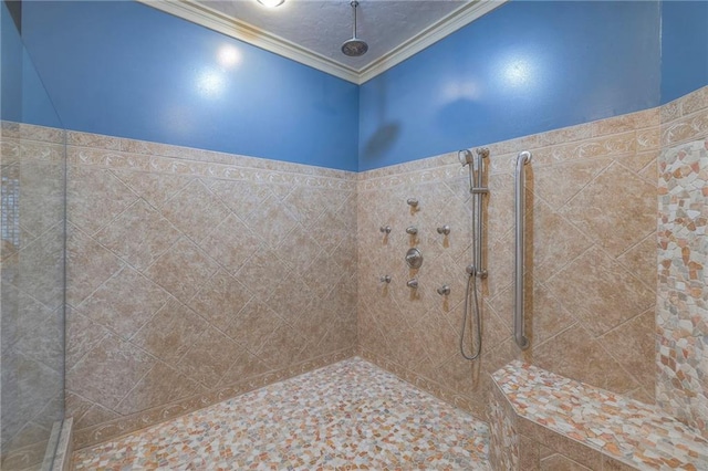 full bathroom featuring ornamental molding and tiled shower