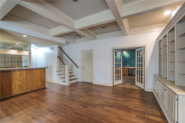 unfurnished living room with stairs, french doors, coffered ceiling, dark wood-style flooring, and beam ceiling
