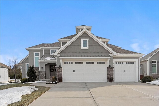 4513 NE Parks Summit Ter, Lees Summit, MO 64064 - craftsman-style home with stone siding, metal roof, a garage, concrete driveway, and a standing seam roof