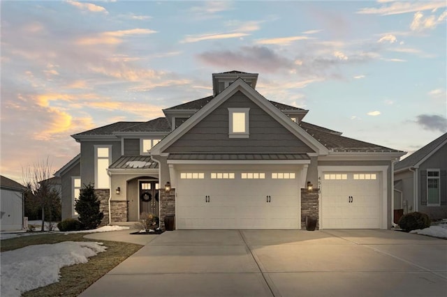 4513 NE Parks Summit Ter, Lees Summit, MO 64064 - craftsman inspired home with a standing seam roof, metal roof, stone siding, an attached garage, and driveway