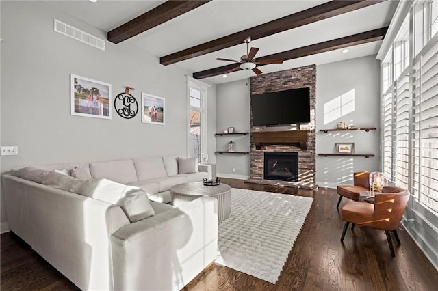 4513 NE Parks Summit Ter, Lees Summit, MO 64064 - living area with dark wood-type flooring, visible vents, a stone fireplace, and ceiling fan