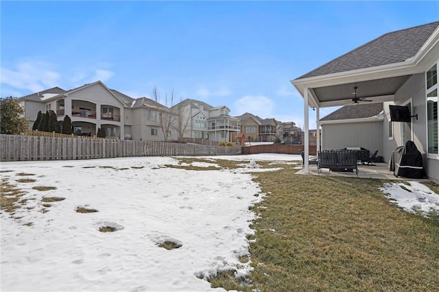 4513 NE Parks Summit Ter, Lees Summit, MO 64064 - yard layered in snow with ceiling fan, fence, a residential view, and a patio area