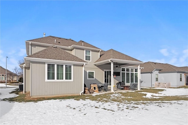 4513 NE Parks Summit Ter, Lees Summit, MO 64064 - snow covered back of property with a ceiling fan, central air condition unit, a patio, and roof with shingles