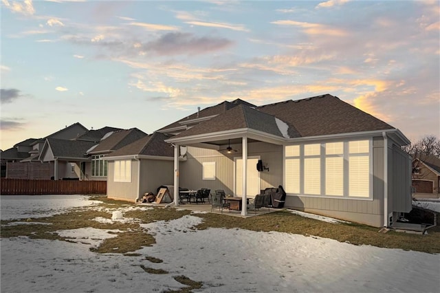 4513 NE Parks Summit Ter, Lees Summit, MO 64064 - snow covered property with a patio, fence, and a shingled roof