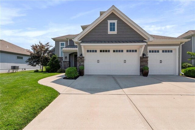 4513 NE Parks Summit Ter, Lees Summit, MO 64064 - craftsman-style home with stone siding, an attached garage, a standing seam roof, driveway, and a front lawn