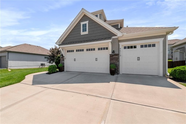 4513 NE Parks Summit Ter, Lees Summit, MO 64064 - view of front of house with an attached garage, concrete driveway, stone siding, a standing seam roof, and a metal roof