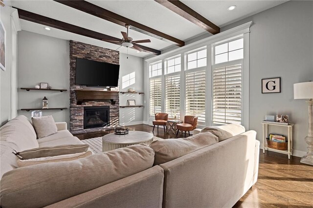4513 NE Parks Summit Ter, Lees Summit, MO 64064 - living room with ceiling fan, a stone fireplace, beamed ceiling, wood finished floors, and recessed lighting