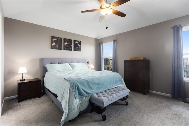 bedroom featuring vaulted ceiling, baseboards, a ceiling fan, and carpet floors